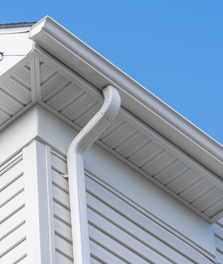 White vinyl gutters corner downspout