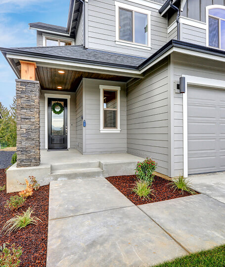 Gray modern craftsman stone accent entry with garage