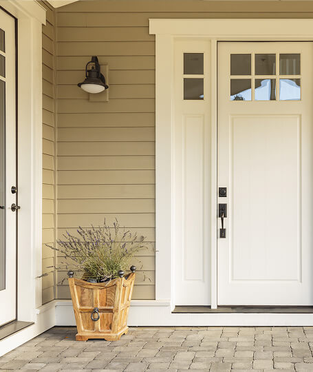 Tan lap siding craftsman entry door close up